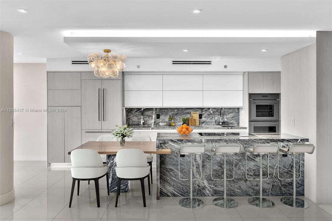 CUSTOM DESIGNED KITCHEN WITH GORGEOUS CABINETRY, THE FINEST APPLIANCES, AND NATURAL STONE