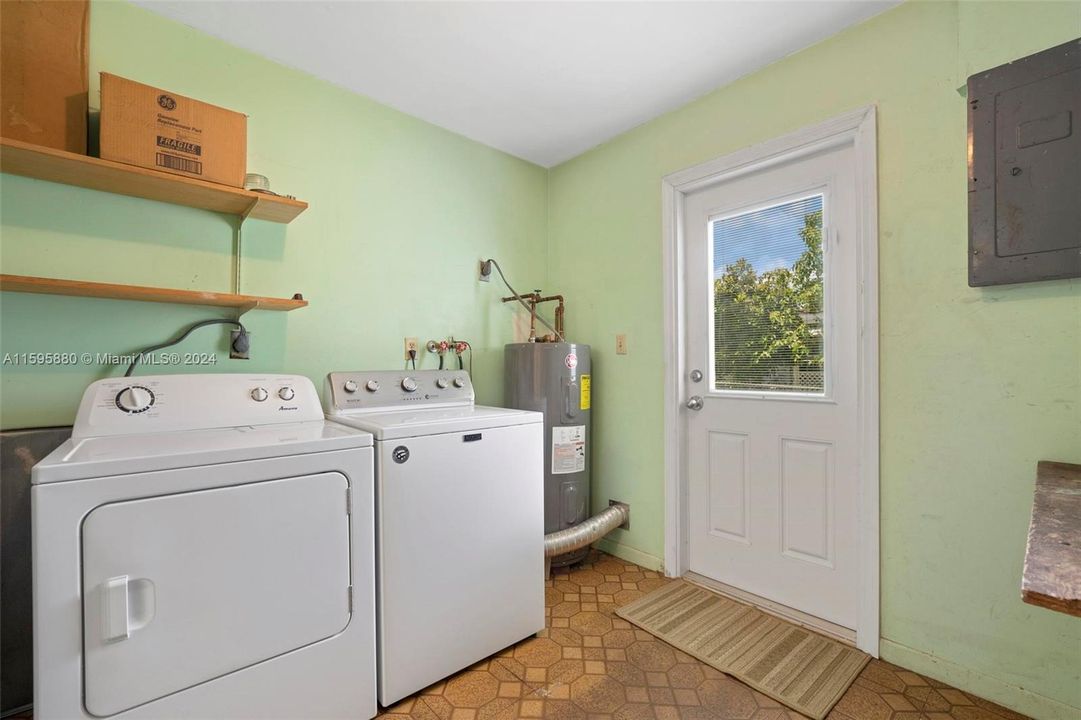 The laundry room connects from the kitchen to the back yard.