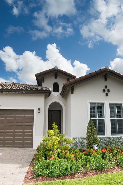 Beautiful landscaping adorns the exterior of the house.