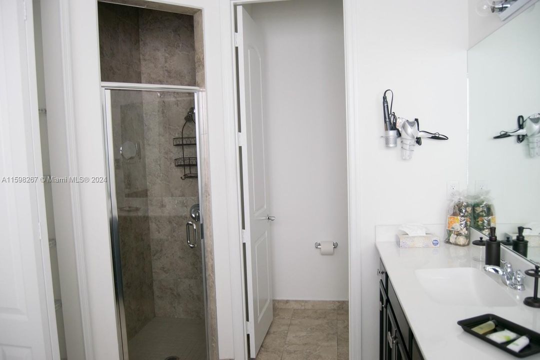 The master bathroom also has a standing shower with elegant glass doors.