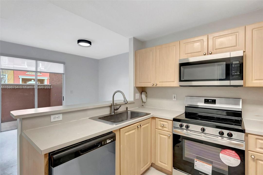 Overlooking family room and patio with new appliances
