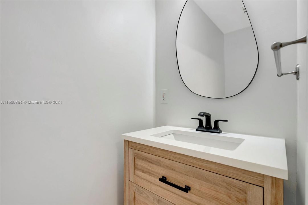 Powder room located downstairs for guests