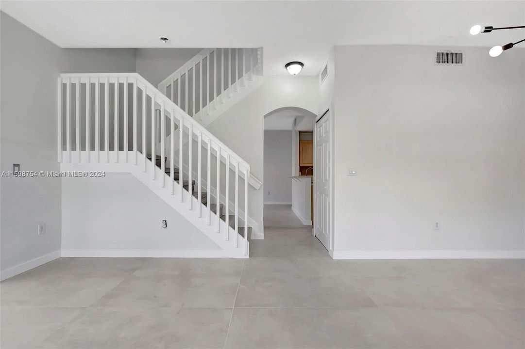 Staircase leading to three bedrooms upstairs