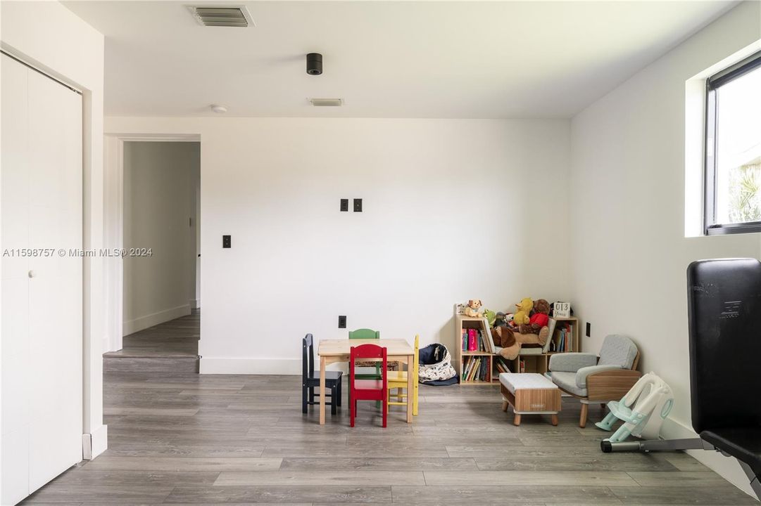 Converted garage with air conditioning and ample space for a play room or regular room