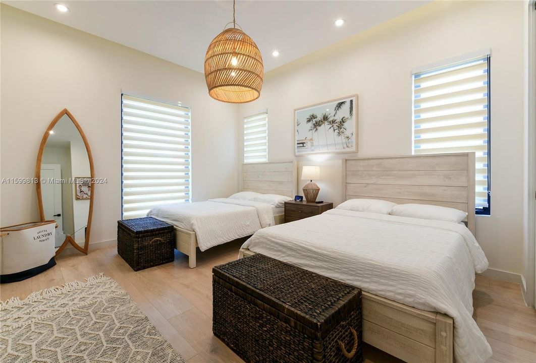 Double Bedroom: This spacious bedroom with two beds is perfect for family or friends, offering a bright, airy atmosphere and beach-inspired decor to ensure everyone feels welcome.