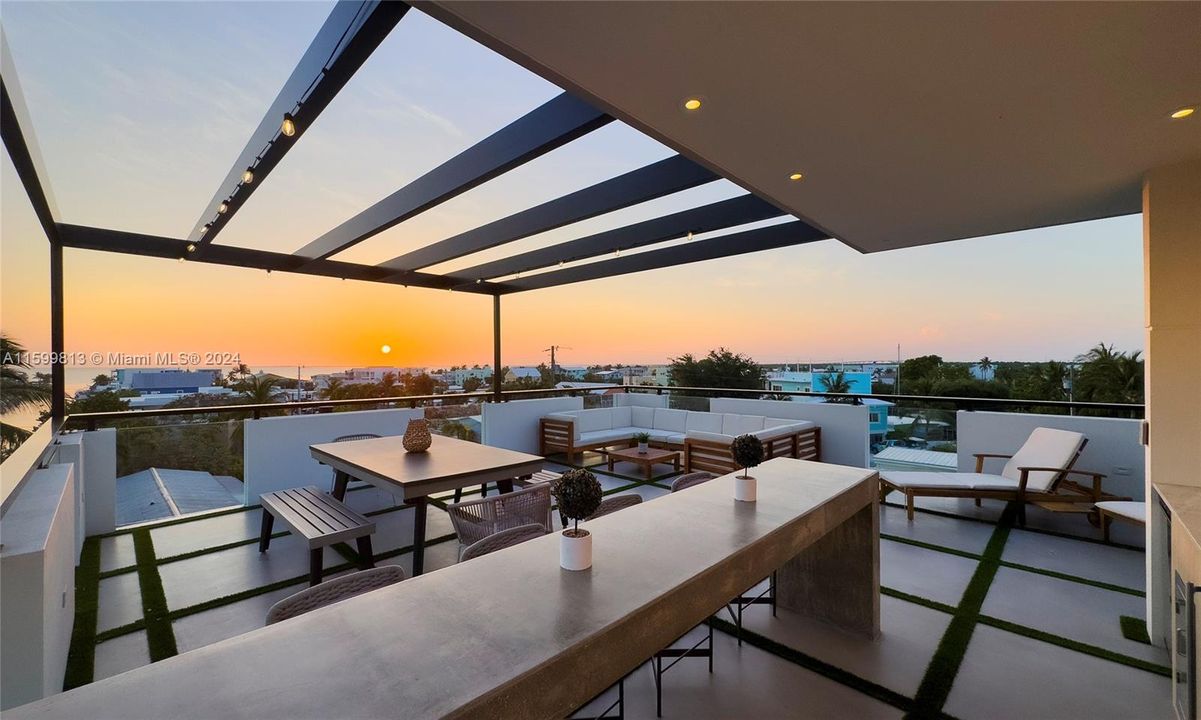 Roof Top Terrace at Sunset: Experience the magic of sunset from your rooftop terrace. With ample seating and open space, it's the perfect spot for relaxation and enjoying the vibrant colors of the sky and every day life in the Keys.