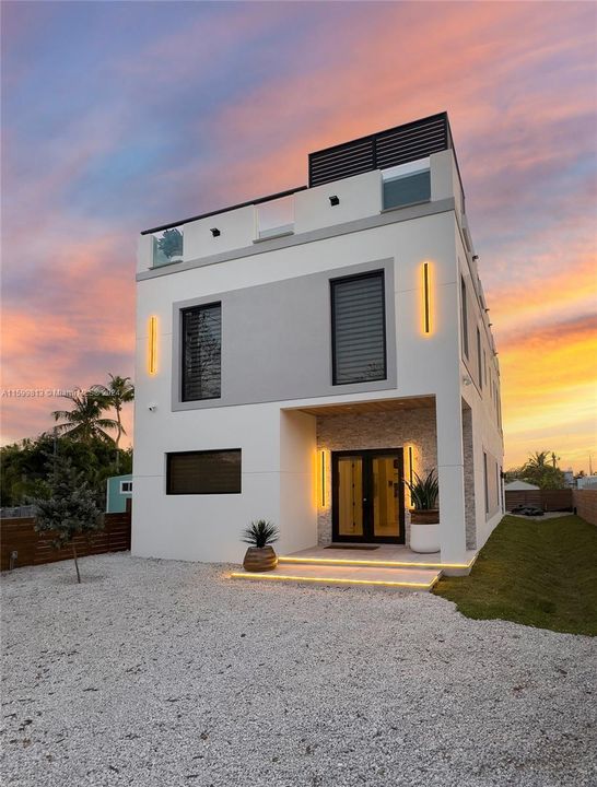 Front Exterior at Dusk: Welcome home to this stunning property, beautifully illuminated against the evening sky. The modern design and warm exterior lighting create an inviting first impression.