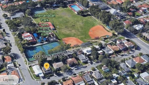 Yard with mango tree backs up to Shenandoah Park