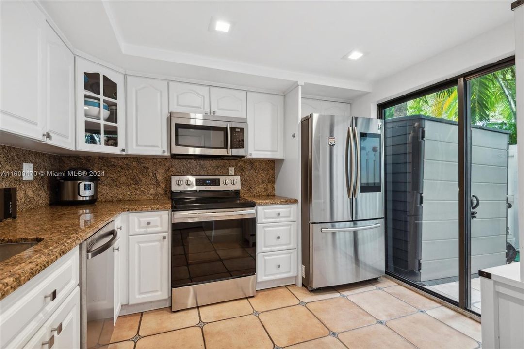 Kitchen Area w/ Enclosed Patio in Front.