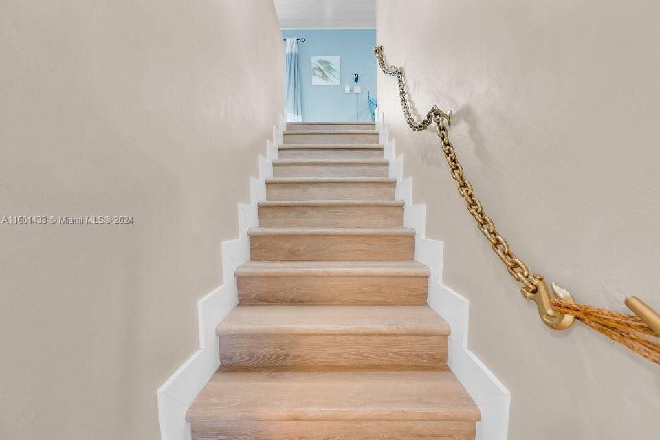 The nautical accent staircase shows thelevel of perfection and detail throughout this residence