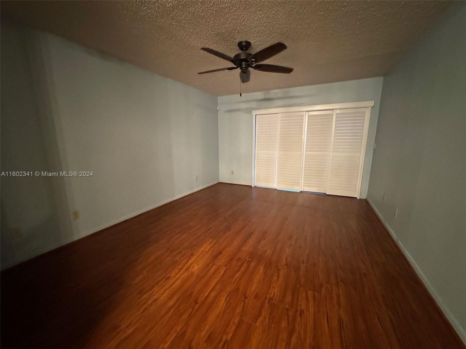 Primary bedroom with space for sitting area, Plantation Shutters on large sliders to the private screened patio.