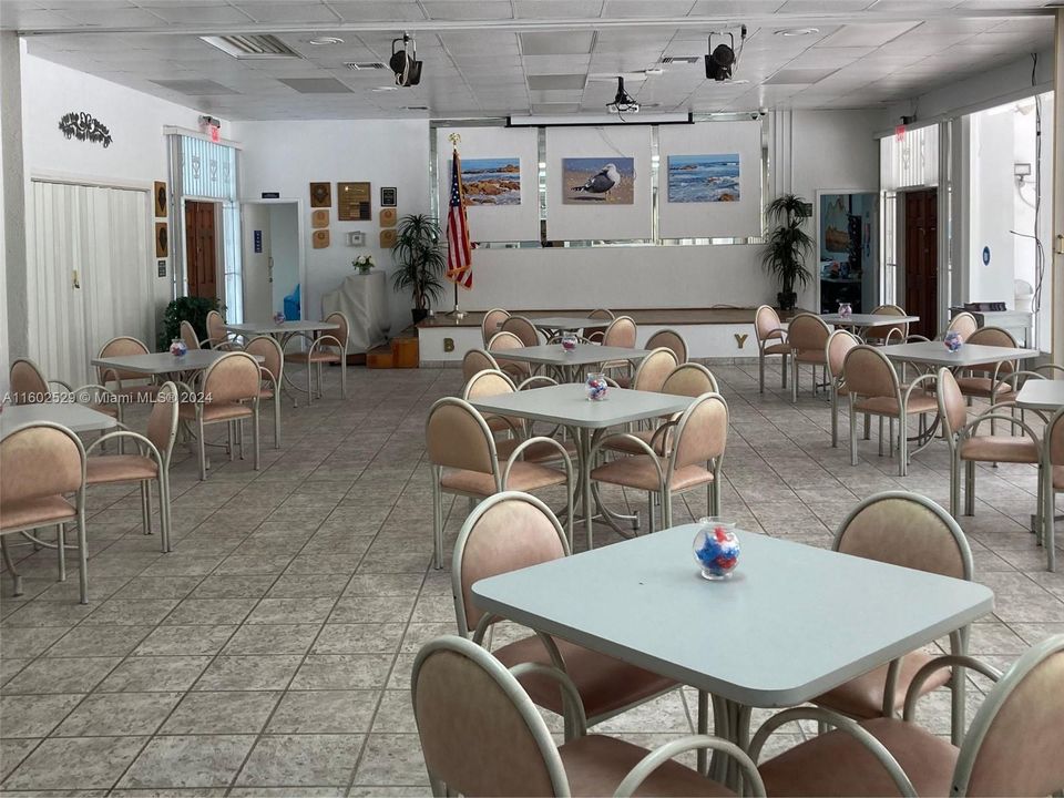 Social room where residents meet, play cards, work and socialize with neighbors.