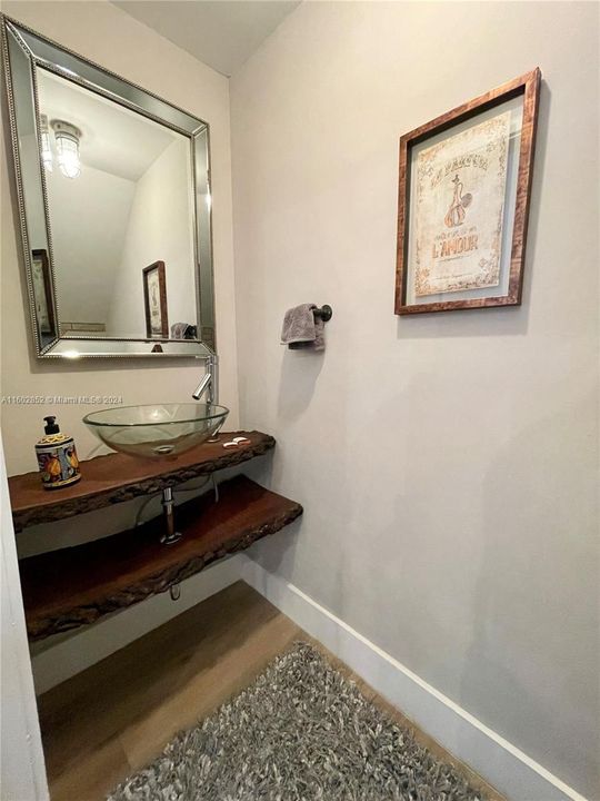 Powder room downstairs with rustic solid wood counter