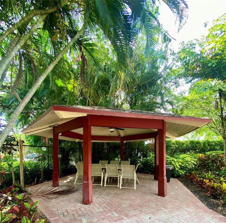 Covered sitting area next to pool