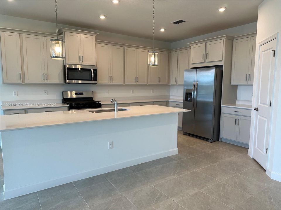 Oversized kitchen island with breakfast bar.