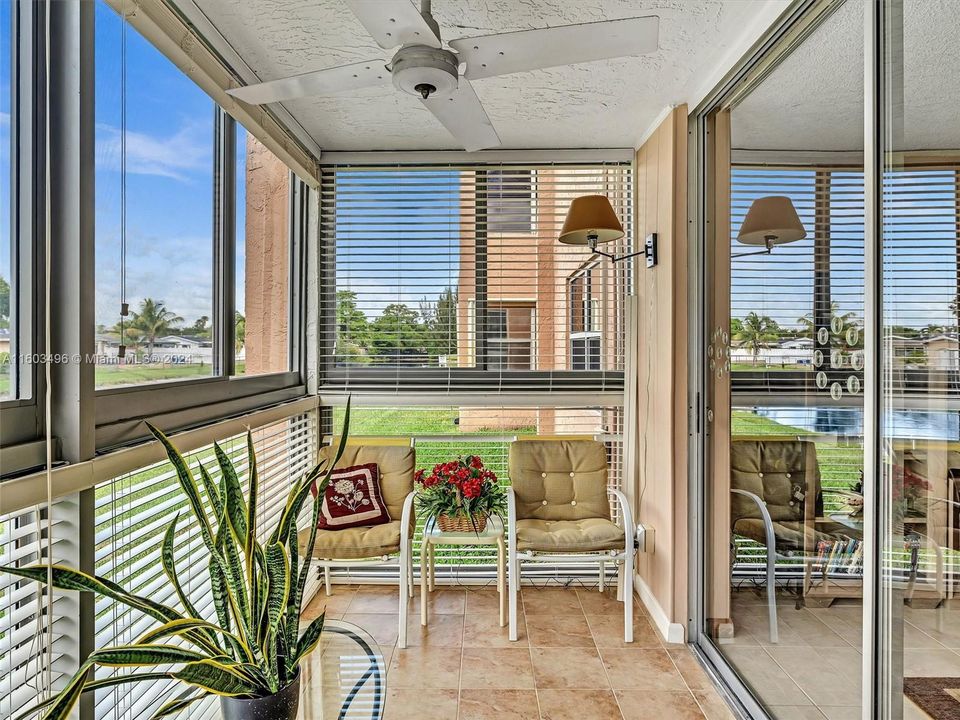 Enclosed Patio features Impact Windows, overlooking the garden and canal