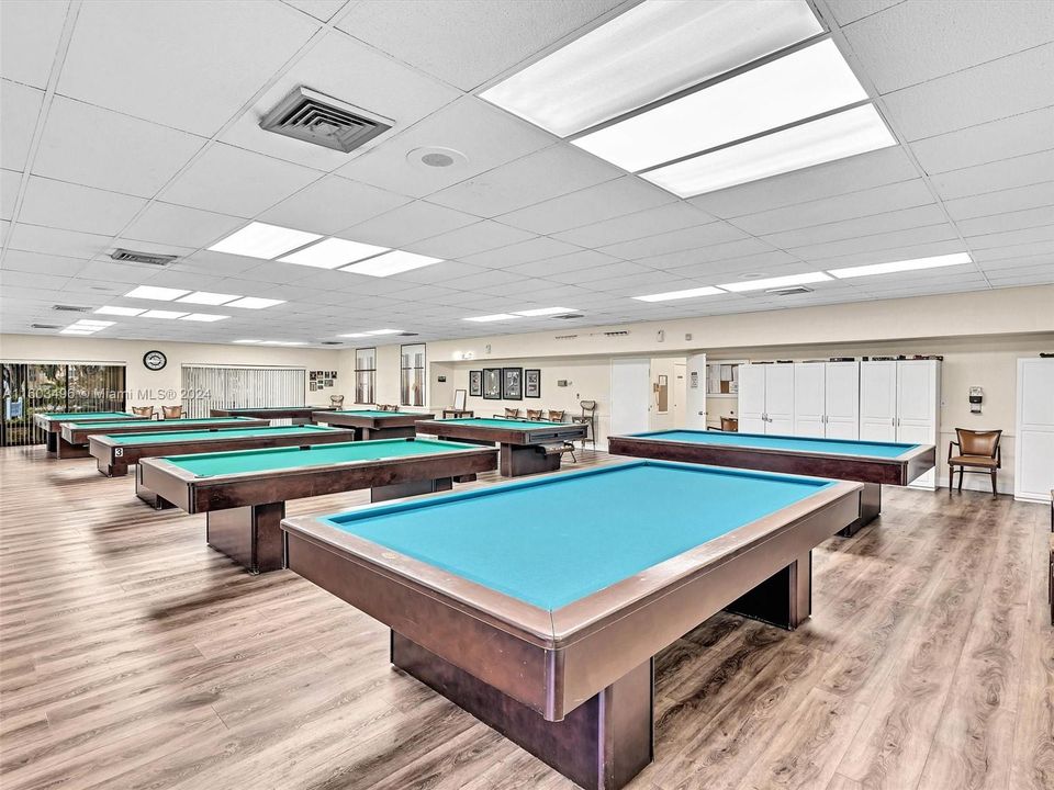 Beautiful clubhouse with plenty of amenities, including indoor and outdoor heated pools, a gym, racquetball and tennis courts, a theater, a billiard room, card rooms, a library, BBQ areas, and more.