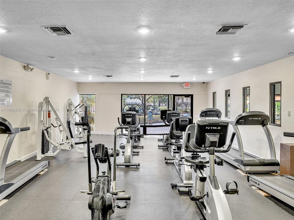 Beautiful clubhouse with plenty of amenities, including indoor and outdoor heated pools, a gym, racquetball and tennis courts, a theater, a billiard room, card rooms, a library, BBQ areas, and more.