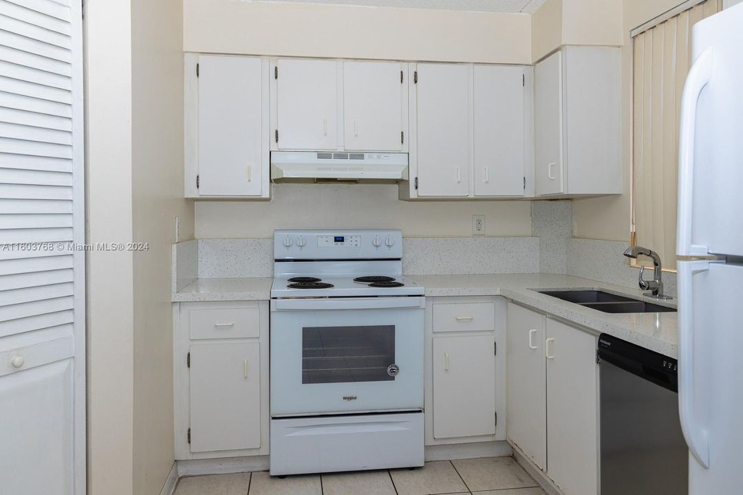 Kitchen with newer appliances and brand-new quartz counterops.