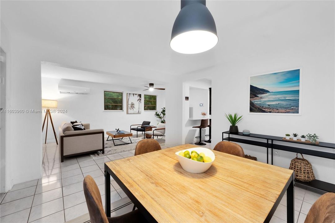 Dining Room flowing into Living Room with pass through Kitchen Bar.