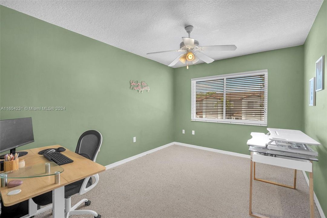 3rd bedroom used here as an additional office.  There is a closet present in this bedroom