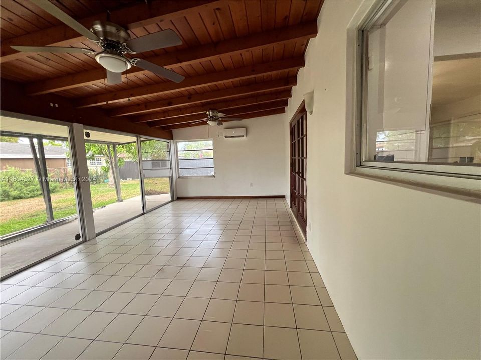 Enclosed back porch with air conditioner