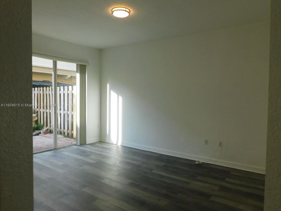 Family room overlooks fenced patio with pavered deckl.