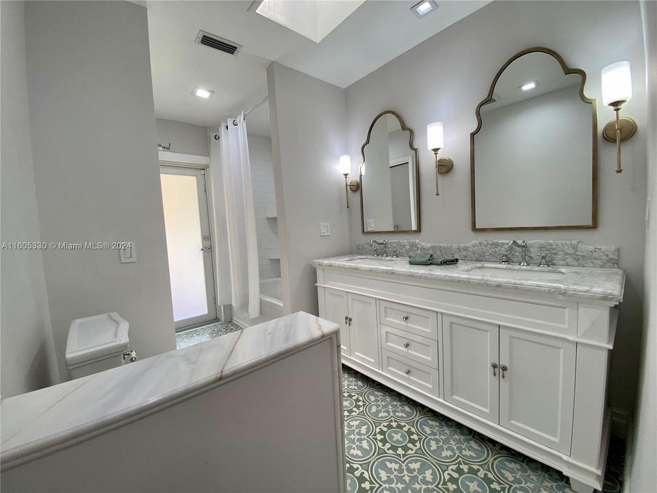 Kids, guest bathroom with double vanity and tub/ shower conbo