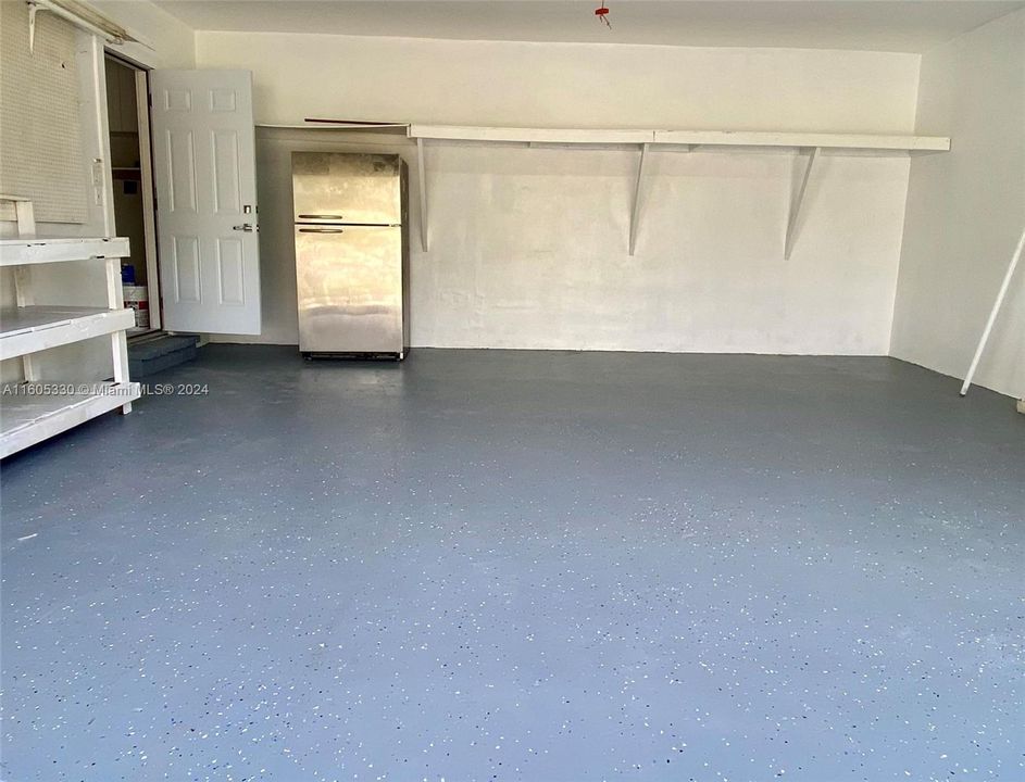 2 car garage with lots of shelving storage and additional refrigerator/ freezer