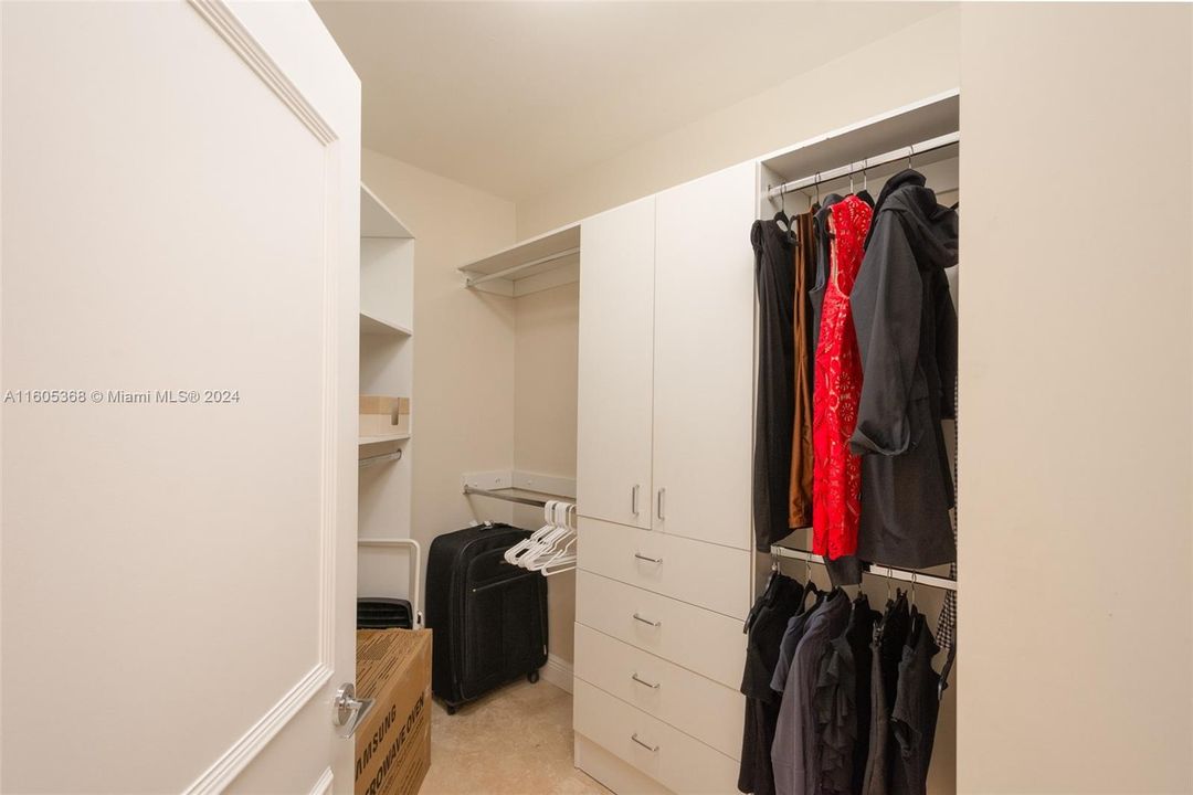 1 of 2 primary bedroom walk in closets