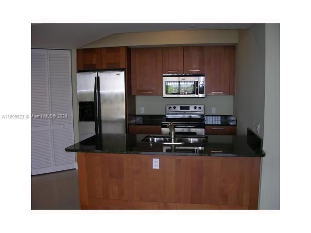 Open concept in the Kitchen, stainless steel appliances and pantry