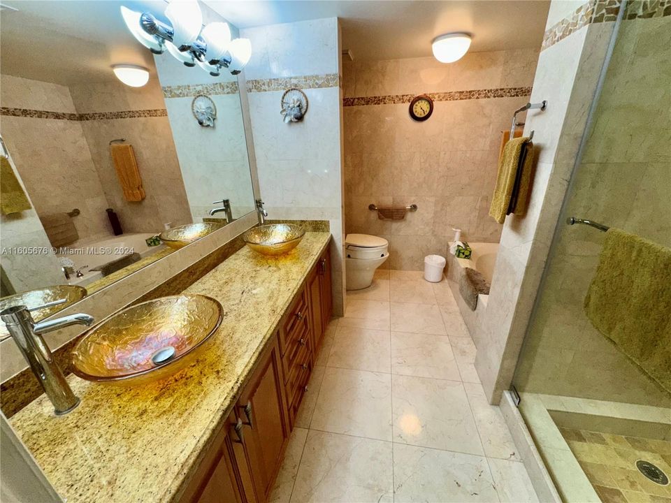 NEW CUSTOM DESIGNER SOLID CHERRY WOOD & CORSICAN GRANITE MASTER BATH WITH GOLD CRYSTALINE VESSEL SINKS AND CUSTOM  MARBLE FLOOR TO CIELING, WITH CUSTOM STONE INLAYS ON THE WALLS AND IN THE SHOWER, "NONSLIP" TUMBLED MARBLE SHOWER FLOOR WITH BODY SPRAY