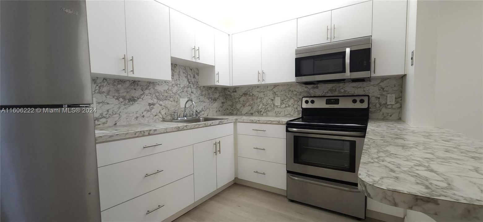 spacious and remodeled kitchen with stainless steel appliances