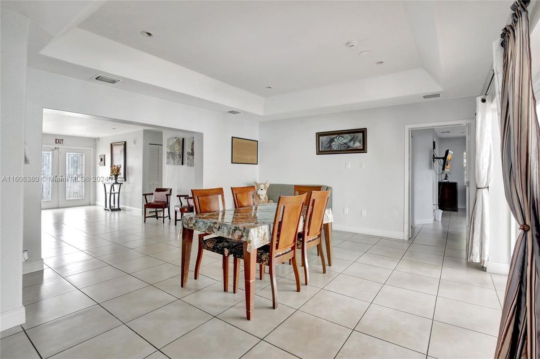 Spacious dining area that can easily accommodate an 8 chair dining table with a buffet table on the side.