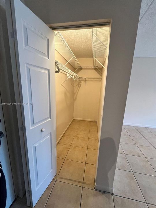 This walk-in closet is at the entry of the unit on the left side opposite the kitchen.