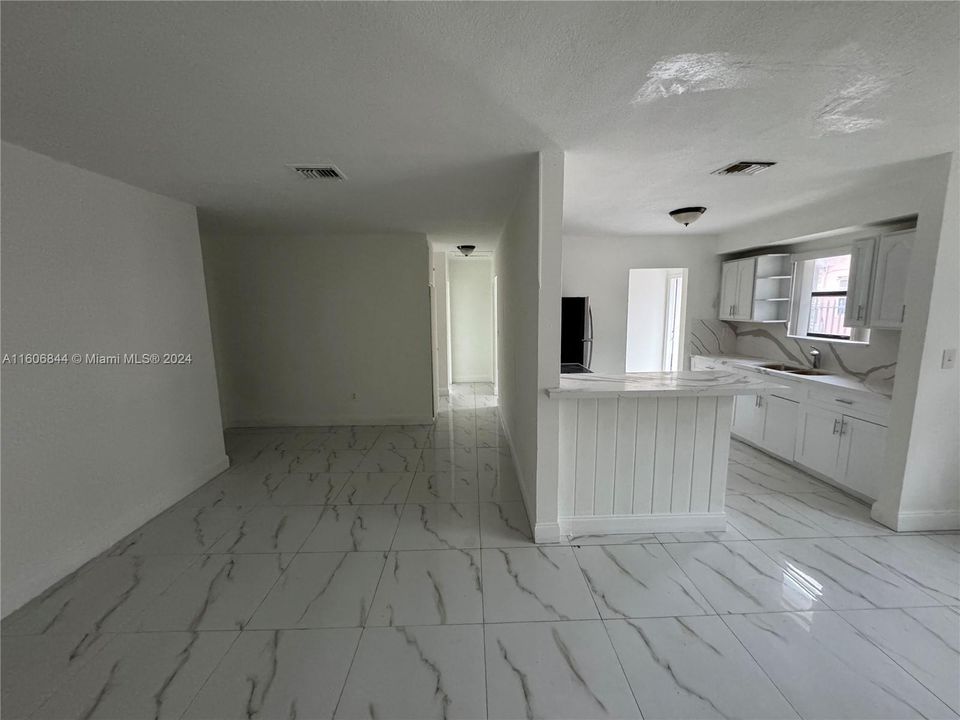 Corner view of Living Room, Dining Room, Kitchen and Hallway to Bedroom 2 + 3