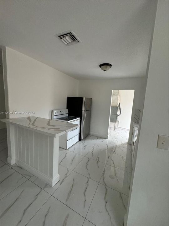 Kitchen with entrance to potential laundry room