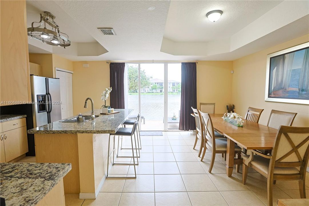 large Kitchen and dining room with Lake view and entrance to the paved patio