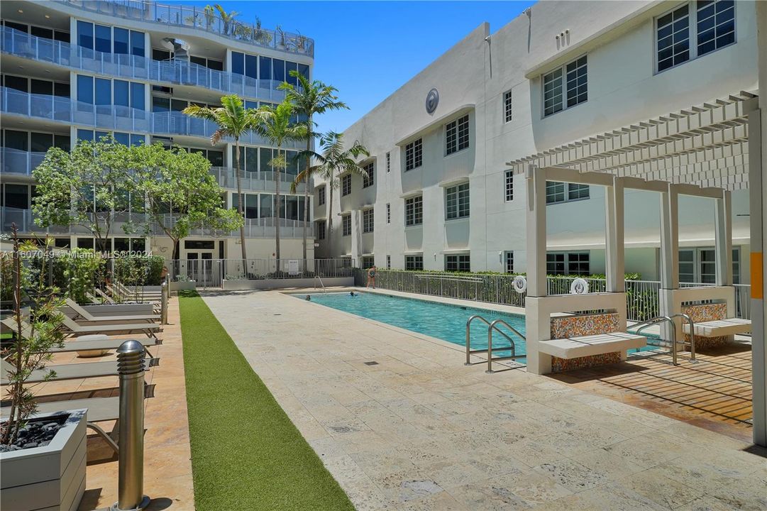 Pool with lounge chairs, cabanas