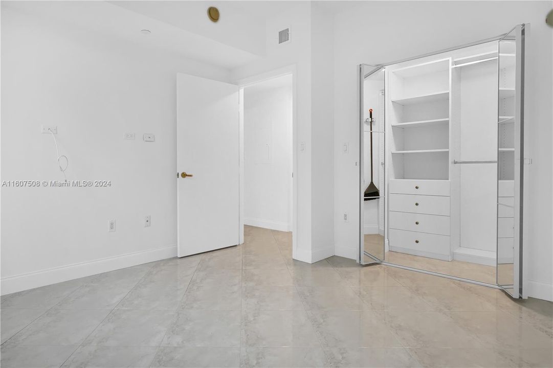 Second Bedroom with ample closet and mirror folding doors.