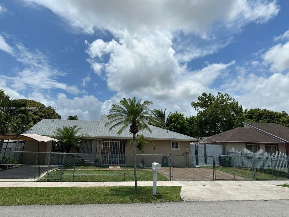 Single story home with a front lawn