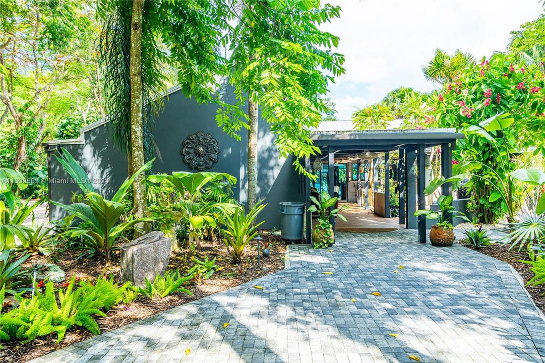 the MAIN is wrapped in impact glass windows and doors. You are greeted by an amazing courtyard with running water. Lush tropical surroundings in and out. Designed to be on 1 space.
