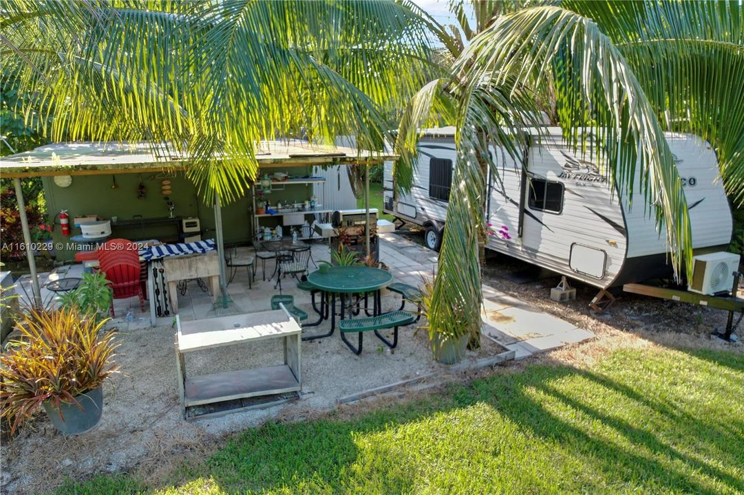 CAMPER NOT INCLUDED ,,POURED CONCRETE PATIO AREA WITH CONTAINER / STORAGE AREA ADJACENT.