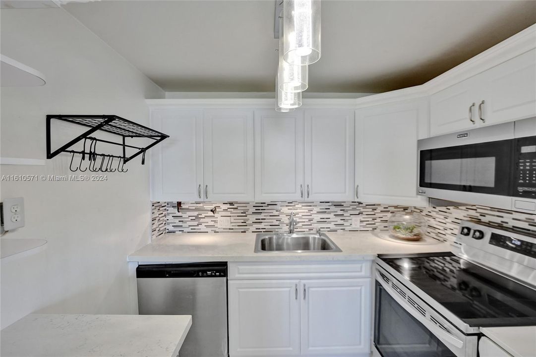 Beautiful kitchen with stainless steel appliances. Solid surface counter tops.
