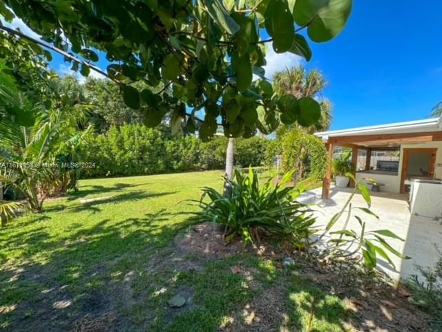 well landscaped yard with fence and fruit trees