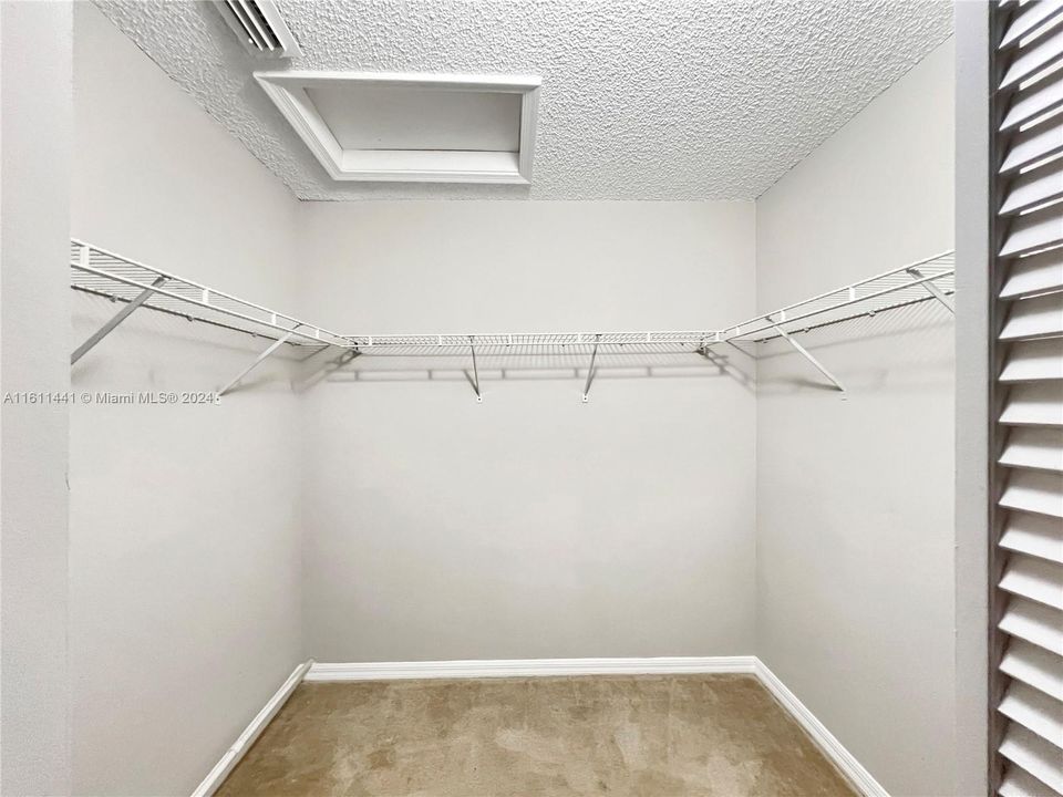 Primary bedroom walk-in closet