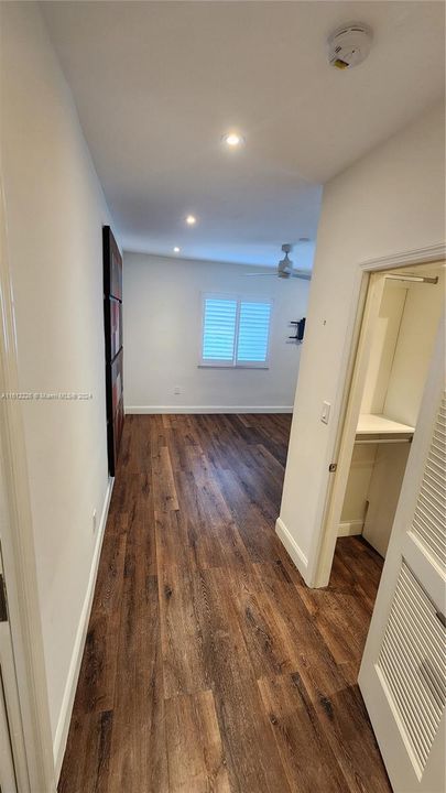 Hallway to Built-out Closet and Bedroom