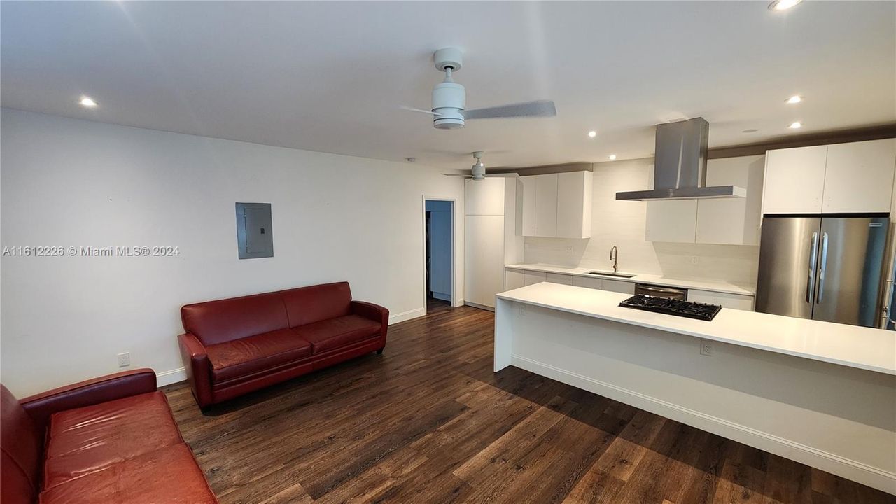 Spacious living room area with high-end, wood-like luxury vinyl tiles.