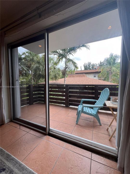 Couch view in living room to balcony door