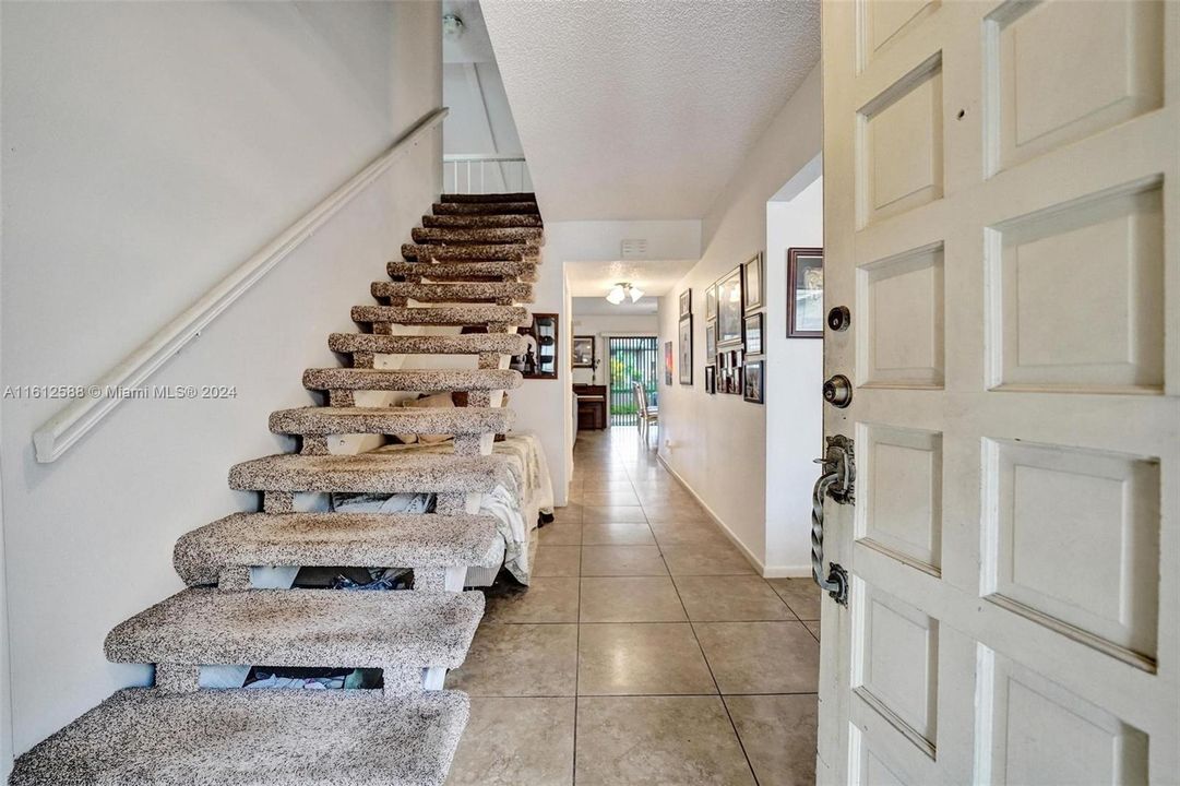 Upon entering, the staircase is to the right. Main living area straight ahead.